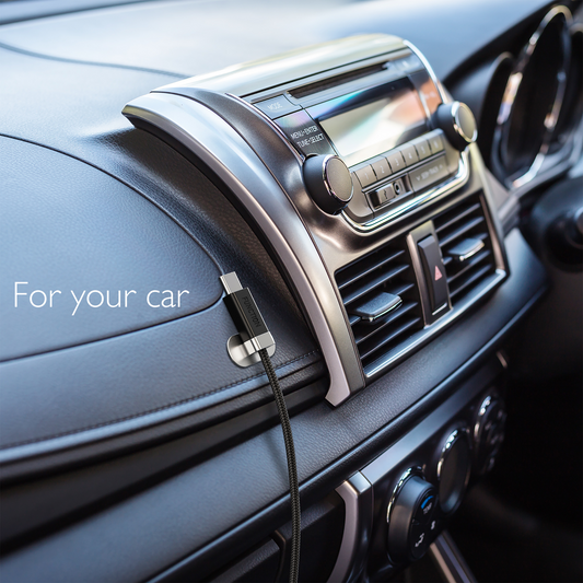 Car dashboard with a Stay Cable USB cable magentically connected by a metal plate