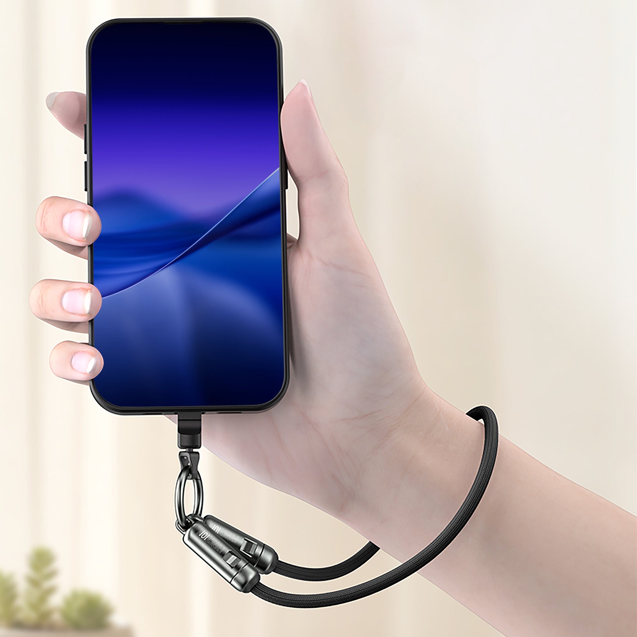 Hand holding a smartphone with a charging cable attached on a neutral background