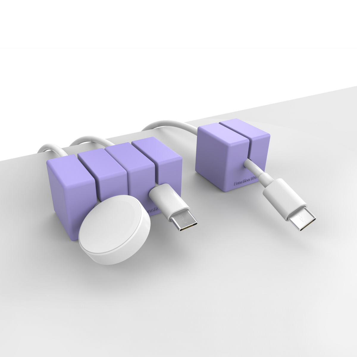 3 CABLE BLOCKS Magnetic and Weighted Cord Organizers in Purple on end of a table.