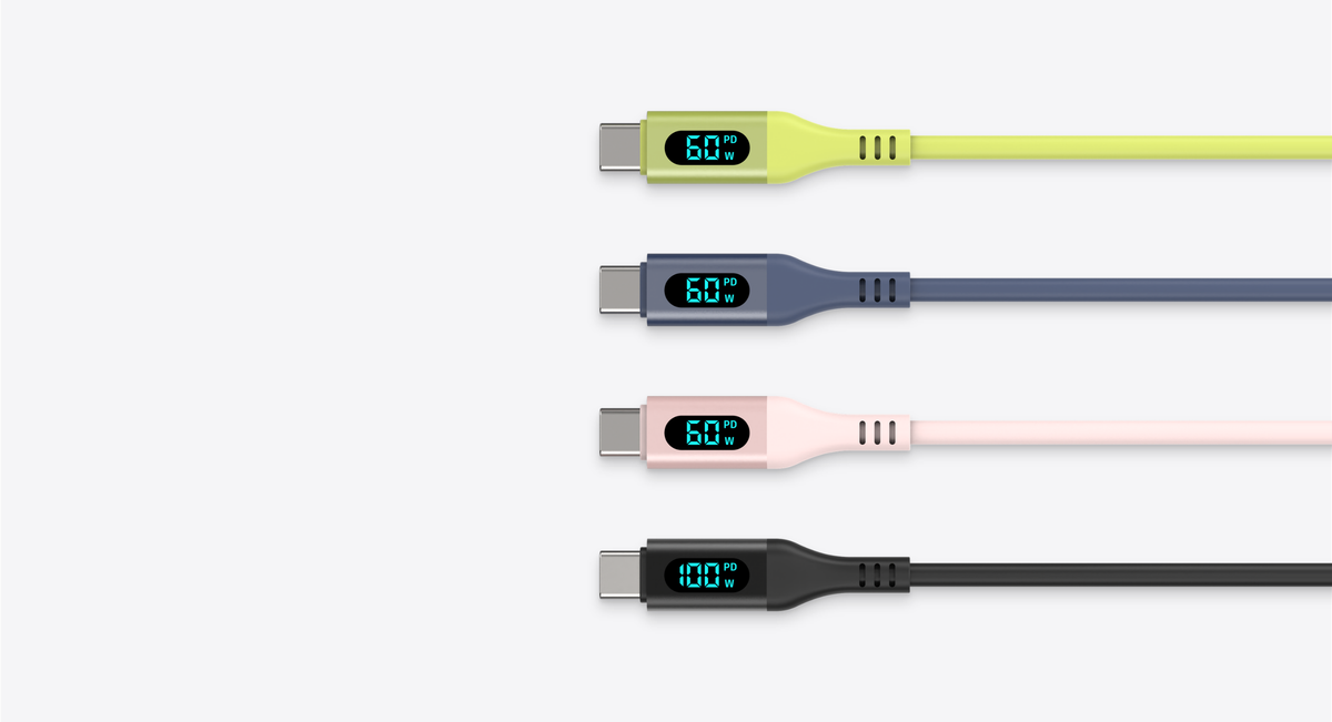 Three SMART CABLE USB-C cables in pink, lime and slate, each showing live charging wattage on its digital display