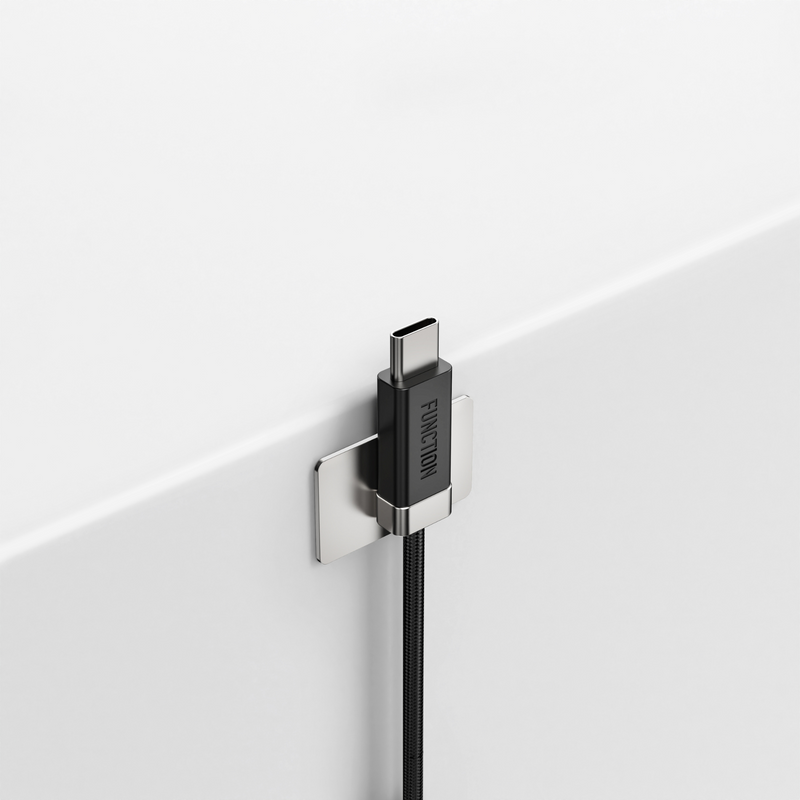 Close-up of a USB-C cable with a black connector and magnet on a white background