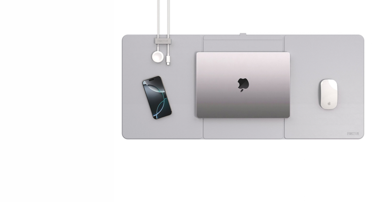 WorkPad Pro desk mat with a MacBook, iPhone and mouse, cable held by the magnetic manager